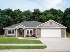 a house with two garages in the front yard