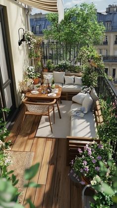 an outdoor patio with wooden flooring and white pillows on the couches, plants and potted trees