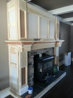 a room with a fire place in the middle and shelves on the wall above it