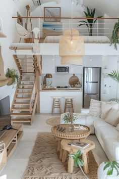 a living room filled with furniture and a fire place next to a stair case in front of a tv