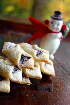 small pastries on a wooden table with a snowman figurine in the background