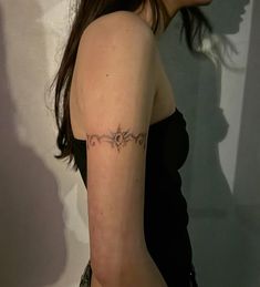 a woman with a tattoo on her left arm and the word love written in cursive writing