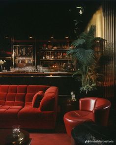 a red couch sitting in front of a bar