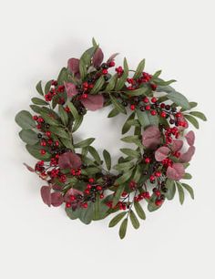 a wreath with red berries and green leaves