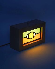 an illuminated box with the eye on it's side and light coming out from inside