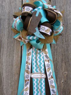 a blue and brown ribbon tied to a wooden fence