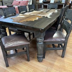 a wooden table with leather chairs around it