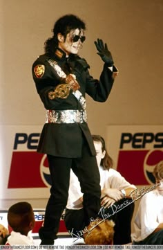 a man dressed as michael jackson on stage