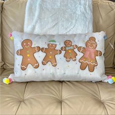 a pillow with three gingerbreads on it