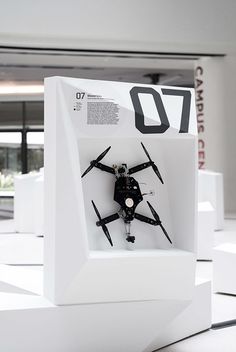 a clock made out of legos on display in a white box with black numbers