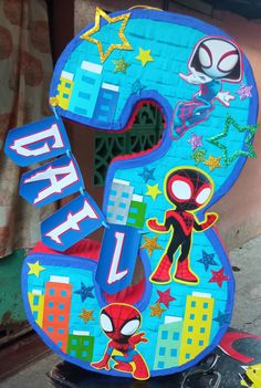 the number five is made out of cardboard and has spiderman characters painted on it