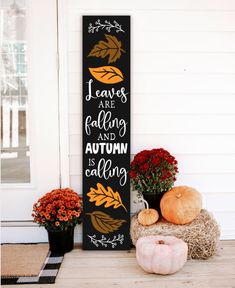 a wooden sign that says leaves are falling and autumn is calling on the front porch