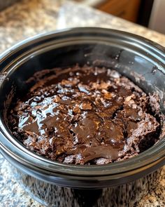 a crock pot filled with chocolate cake on top of a counter