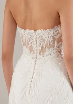 the back of a wedding dress with beading and sequins