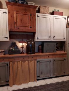 a kitchen with wooden cabinets and white cupboards