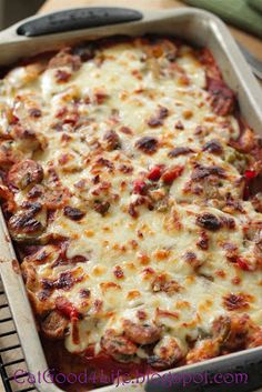 a casserole dish with meat and cheese in it