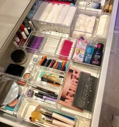 an organized drawer is shown with makeup and other items