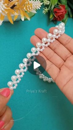 someone is holding some pearls in their hand and the beads have been beaded together