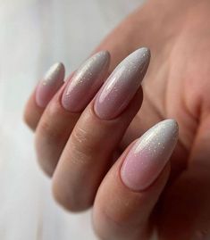 a woman's hand with some pink and white nails