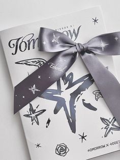 a close up of a card with a bow on it's side and the words tomorrow written in black ink