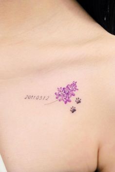 a woman with a tattoo on her chest has a dog's paw and flower