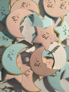 some pink, blue and white paper cut outs with words that say it's girl