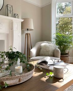 a living room filled with furniture and a fire place in front of a large window