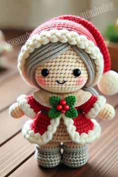 a small crocheted doll wearing a red and white hat