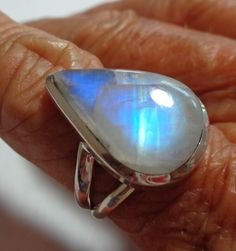 "Vintage rainbow moonstone ring with bright aqua blue to deep cobalt blue flash in a solid sterling silver ring The spectacular colors in this gem range from pale aqua to peacock blue to deep cobalt blue throughout the gorgeous pear moonstone. The pearl rainbow moonstone ring is a size 7. The ring is well crafted of solid sterling silver, and has an open back so the lovely moonstone energy can be felt on your finger. This vintage ring was stored carefully, and has been cleaned and polished. It i Fusion Style Oval Moonstone Ring Gift, Oval Moonstone Fusion Ring Gift, Fusion Style Moonstone Jewelry For Anniversary, Unique Large Moonstone Ring, Unique Moonstone Ring With Large Stone, Fusion Style Moonstone Gemstone Ring For Anniversary, Sterling Silver Round Moonstone Fusion Ring, Fusion Style Anniversary Moonstone Gemstone Ring, Anniversary Fusion Style Moonstone Gemstone Ring