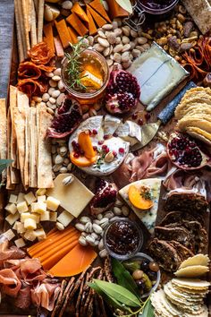 an assortment of cheeses, crackers and other foods