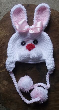 a crocheted bunny hat on top of a wooden table