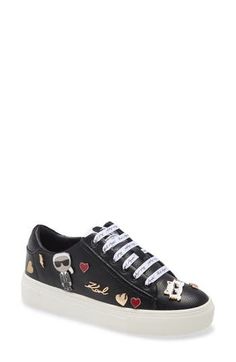 Enamelled pins featuring a portrait of the designer and Choupette herself highlight this low-top leather sneaker with logo-printed ribbon laces. 1" platform Lace-up style Memory foam cushioning Leather upper and lining/rubber sole Imported Women's Shoes Leather Sneakers With Appliqué Logo, Low-top Logo Embellished Sneakers For Streetwear, Trendy Sneakers With Graphic Print And Round Toe, Trendy Graphic Print Round Toe Sneakers, Casual Synthetic Sneakers With Graphic Print, Casual Low-top Sneakers With Appliqué Logo, Casual Platform Lace-up Sneakers With Embroidered Logo, Casual Lace-up Platform Sneakers With Embroidered Logo, Ribbon Laces