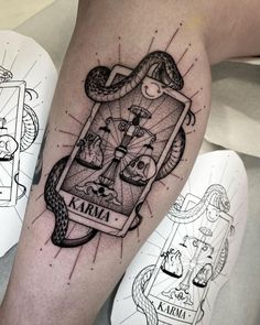 a tattoo on the leg of a person with a snake and playing card in it