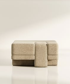 a beige couch sitting on top of a white floor