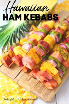 hawaiian ham kebabs on a cutting board with pineapples