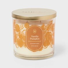 an orange and white candle with the label vanilla pumpkin