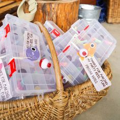 several plastic containers with magnets in them sitting on a wicker basket next to other items