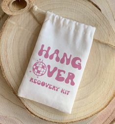 a bag that says hang over recovery kit sitting on top of a piece of wood