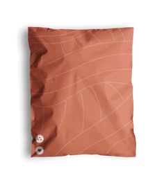 an orange pillow on a white background with a button in the middle that says, i love you