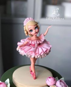 a cake with a doll on top of it