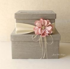 a gray box with a pink flower on it