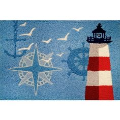 a rug with a lighthouse and seagulls on it