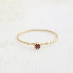 Ruby, July birthstone is set on Envero Jewelry's signature Dahlia setting which has a milgrain around the bezel setting to add elegant and feminine look to this simple ring. Choose from 2 or 3mm natural ruby and solid 14k yellow, rose or white gold. Perfect for simple ruby engagement ring - petite ruby matches perfectly when you wear it with our stack rings. Shop for matching ring: https://www.etsy.com/shop/EnveroJewelry?ref=l2-shopheader-name&section_id=17732059 ♦♦2mm Ruby ring♦♦ :: Small r Elegant Stackable Birthstone Ring, Fine Jewelry Stackable Round Ruby Ring, Stackable Ruby Ring Fine Jewelry, Ruby Birthstone Ring With Round Stone, Stackable Round Ruby Ring Fine Jewelry, Birthstone Ruby Ring, Red Ruby Ring With Bezel Setting, Ruby Birthstone Ring With Round Band, Heirloom Ruby Jewelry With Bezel Setting