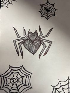 some spider webs and hearts drawn on paper