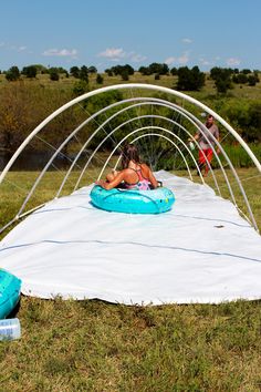 two people on inflatable rafts near an open air swimming area with canopy