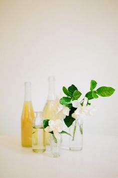 three vases with flowers in them sitting on a table