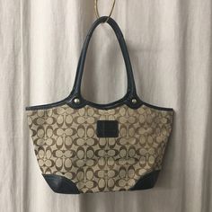 Gorgeous Coach signature handbag.  The color is brown/tan with black leather trim and bottom.  It is lined in a multicolor plaid fabric which is in very good vintage condition.  Has one small stain in front. Check pix.  Measures 24cm x 28cm x 11cm.  The style number is F0893-12369.  Please note that vintage items are not new and may have minor imperfections. For more details and information please send a personal message. You can ask me any question before buying. WORLDWIDE SHIPPING by  DHL Express Estimated time of arrival in 1-3 working days. Handling period 1 business day. Bucket Tote, Black Leather Satchel, Novelty Bags, Plaid Fabric, Tote Purse, Leather Satchel, Leather Trims, Purses And Handbags, Satchel