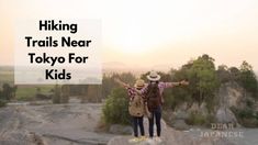 two people standing on top of a rock with the words hiking trails near tokyo for kids