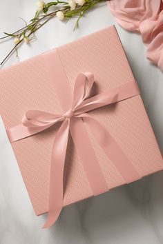 a pink gift box with a bow on it