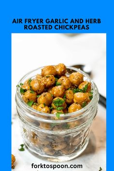 a glass jar filled with roasted chickpeas on top of a white countertop